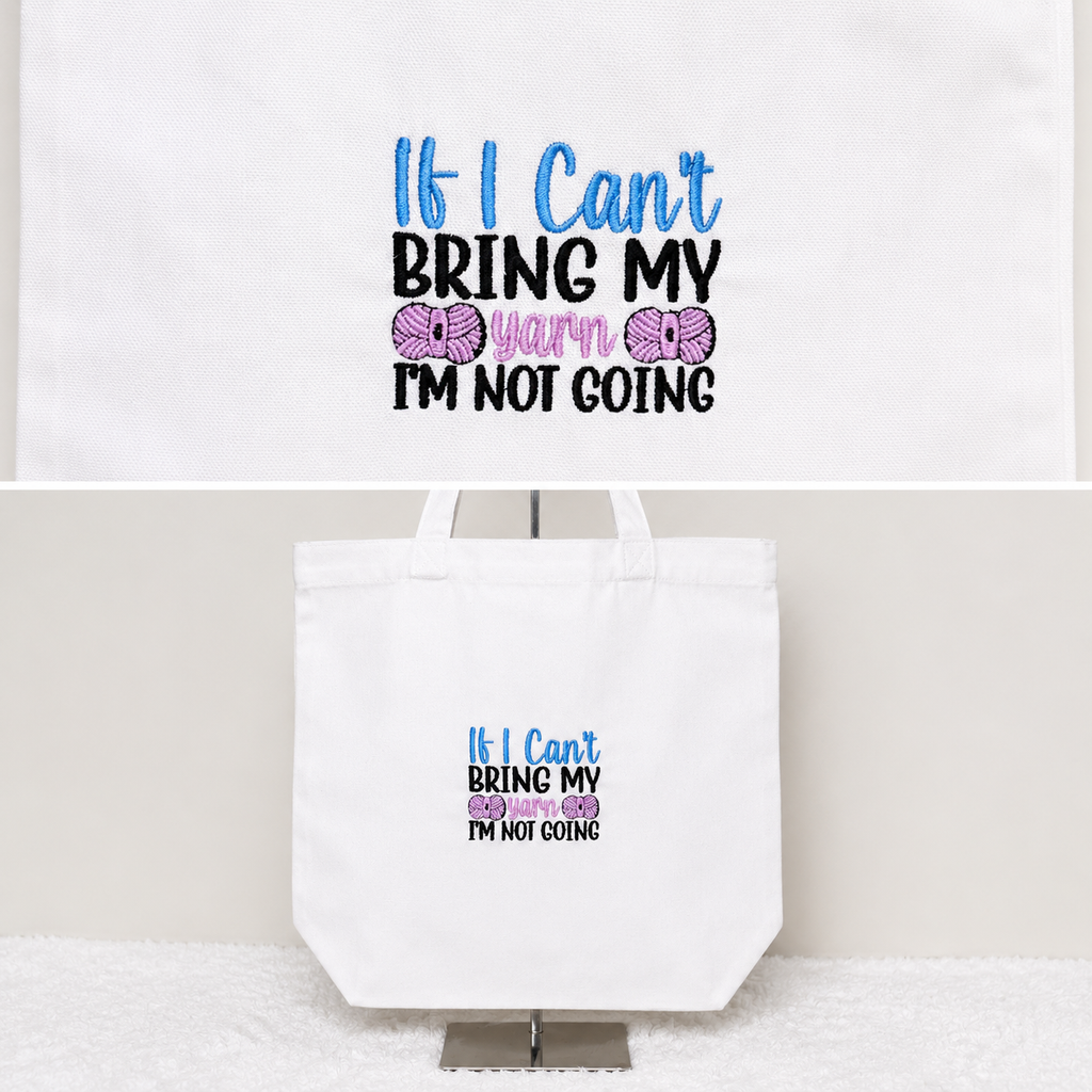 A white canvas tote bag with a printed graphic that reads 'If I Can't BRING MY Yarn Worn GO I'M NOT GOING' in blue, black, and pink text, with pink yarn ball illustrations. The tote bag is displayed on a stand against a light beige wall, with a smaller inset image at the top showing the same print on a white background.