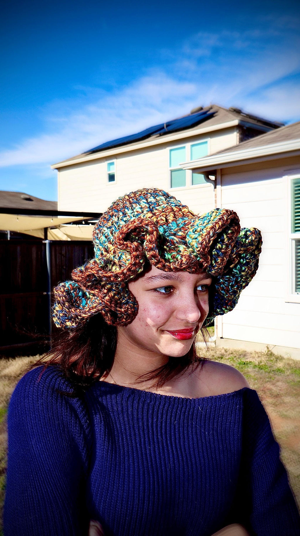 Model wearing ruffle hat in Wildbrush